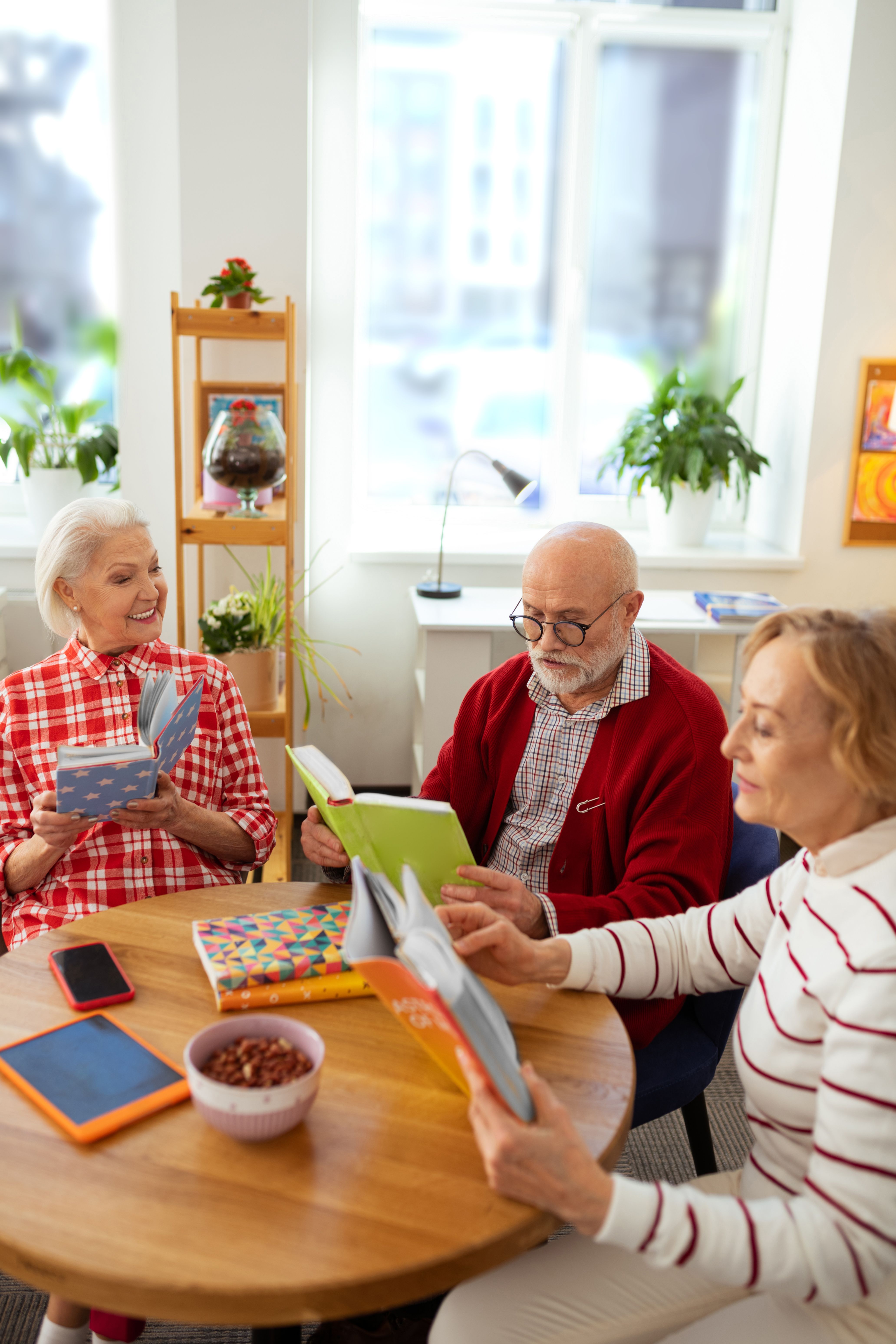 our hobby good looking aged people sitting together while participating reading club